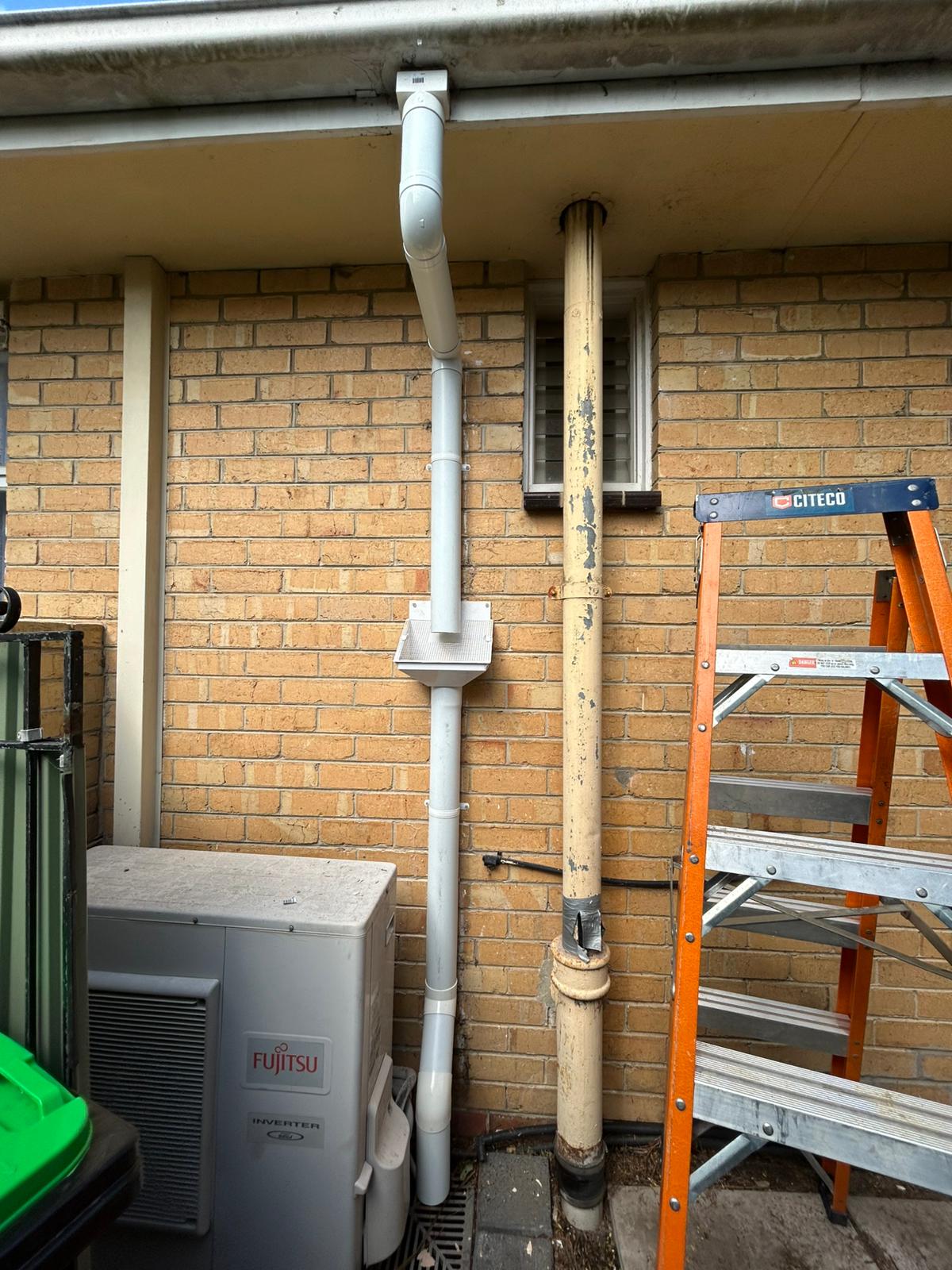 New white PVC vent pipe installed next to old deteriorated pipe Pascoe Vale Melbourne